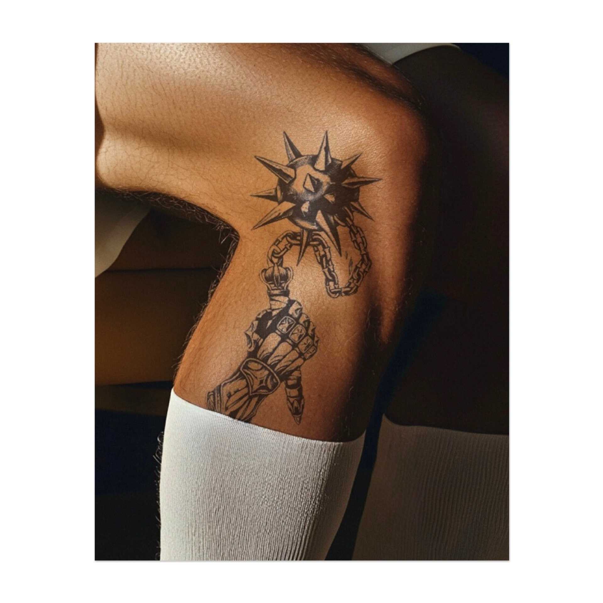 Una mano corazzata che regge una stella del mattino appuntita su una catena. Questo disegno rappresenta forza, resilienza e la capacità di superare le sfide con potenza e determinazione. Ideale per chi abbraccia il proprio spirito guerriero.