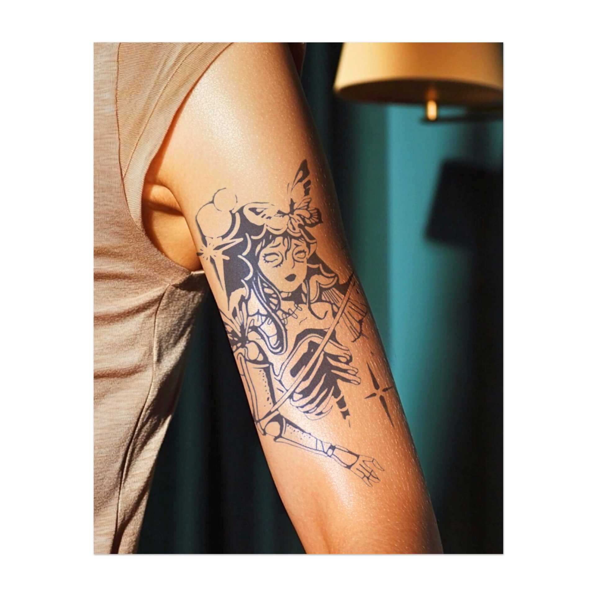 Una figura scheletrica con ali delicate, circondata da stelle e fiori. Questo design combina elementi di vita e morte, magia e trasformazione.