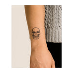 Un grande teschio con un ampio sorriso, simbolo di coraggio e accettazione della mortalità. Questo tatuaggio rappresenta il lato oscuro della vita, abbracciando sia l'inevitabile che la potente forza interiore.